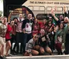 A colorfully wrapped Brew Bus is parked outside the Cigar City Brewing facility advertising brewery tours and various private events