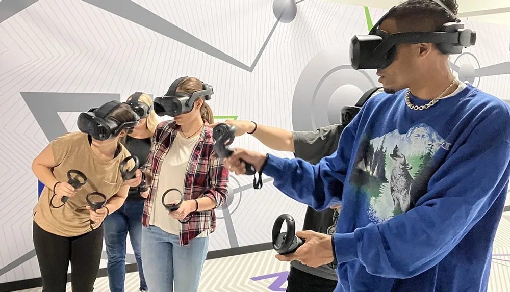 Three people are immersed in a virtual reality experience using headsets and handheld controllers