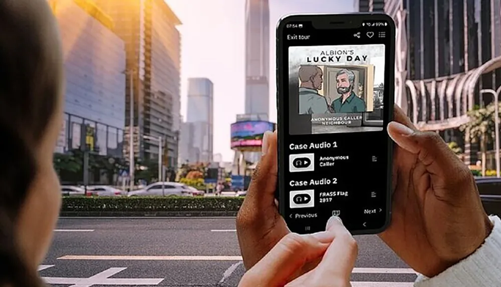 A person is holding a smartphone with a screen showing an audio tour app titled Albions Lucky Day with two audio cases available for listening against an urban backdrop