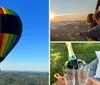 A colorful hot air balloon is soaring over a landscape with a small inset of a smiling couple taking a selfie inside it