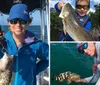 Two people are smiling on a boat each holding a fish they presumably caught while out on the water