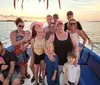 A group of people is enjoying a sunset boat ride together
