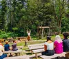 A person in historical attire is giving a demonstration or presentation in a rustic wooden interior possibly a historic or educational setting