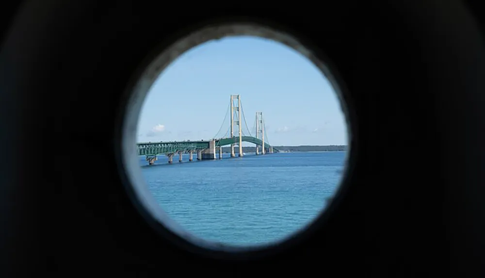 The image shows a bridge over a body of water framed within a circular tunnel-like viewpoint creating a vignette effect