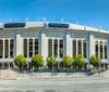 The image shows the exterior of Yankee Stadium a prominent baseball park on a sunny day with clear blue skies