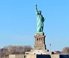 The image features the Statue of Liberty against a clear blue sky symbolizing freedom and democracy