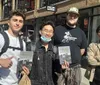 Four individuals are standing outdoors with three of them holding copies of a book titled CASH and one person pointing at a book while two of them smile at the camera and two look on