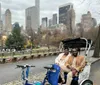 A group of smiling people are enjoying a pedicab ride on a city street during a chilly day