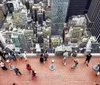 Visitors are enjoying an aerial view of a dense urban skyline from a high observation deck