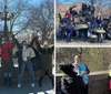 A group of people is posing joyfully with raised arms in front of a fountain in a park on a sunny day