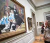 A person is admiring an exhibit within a glass display in what appears to be a museum setting