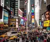 The image shows a bustling Times Square in New York City characterized by its vibrant electronic billboards dense traffic and crowds of pedestrians