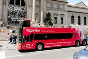 A red double-decker sightseeing bus marked 