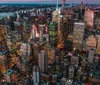 The image captures a bustling Times Square at twilight with illuminated advertisements towering over pedestrians and traffic