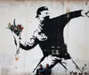 The image shows a stencil graffiti by the artist Banksy depicting a young girl reaching out toward a red heart-shaped balloon