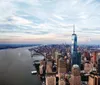 A couple is enjoying a scenic view of a cityscape from a high vantage point with large windows