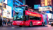 A red open-top sightseeing bus marked 