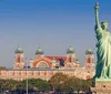 A red and white boat named THE MANHATTAN is filled with passengers near the Statue of Liberty under a clear blue sky