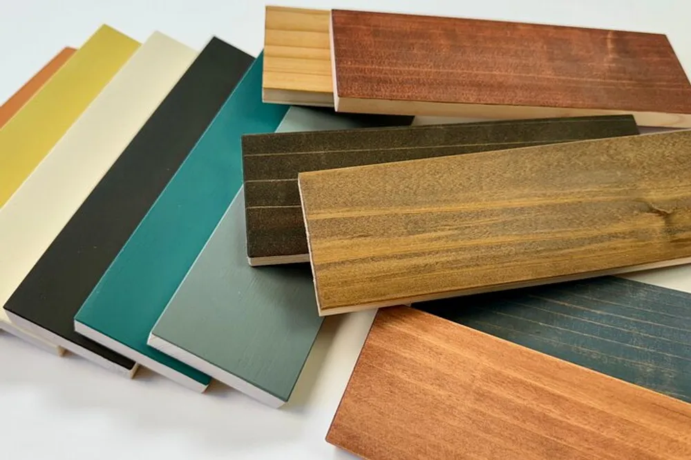 The image shows a selection of colorfully painted and natural wood samples possibly for flooring or furniture arranged in a fan-like spread on a light background