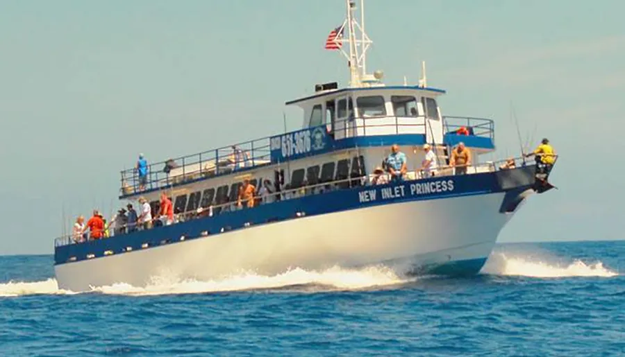 A boat named NEW INLET PRINCESS is advertised with a promise of guaranteed dolphin sightings for passengers on board.