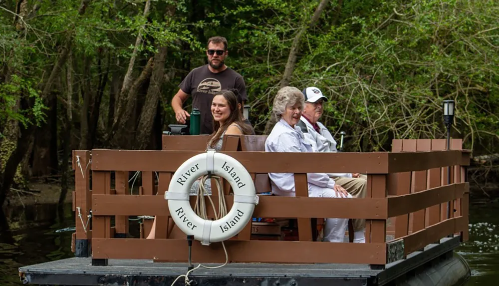 A group of people are enjoying a boat ride through a forested waterway