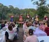 A person is performing a fire dance in traditional attire with an inset image of a dish likely implying a theme related to Polynesian culture or cuisine