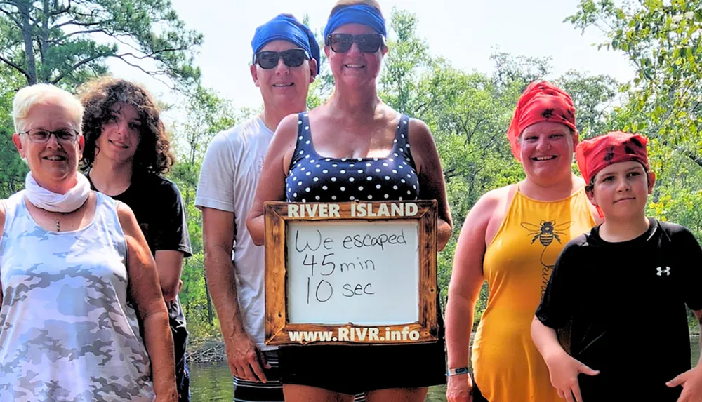 A smiling group of six people poses behind a sign that says We escaped 45 min 10 sec suggesting they successfully completed an escape room challenge