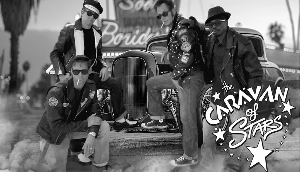 Four men in rockabilly attire pose around a classic car exuding a vintage biker vibe with The Caravan of Stars written on the image