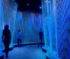 Visitors are exploring a museum exhibit featuring the Liberty Bell with historical displays in the background