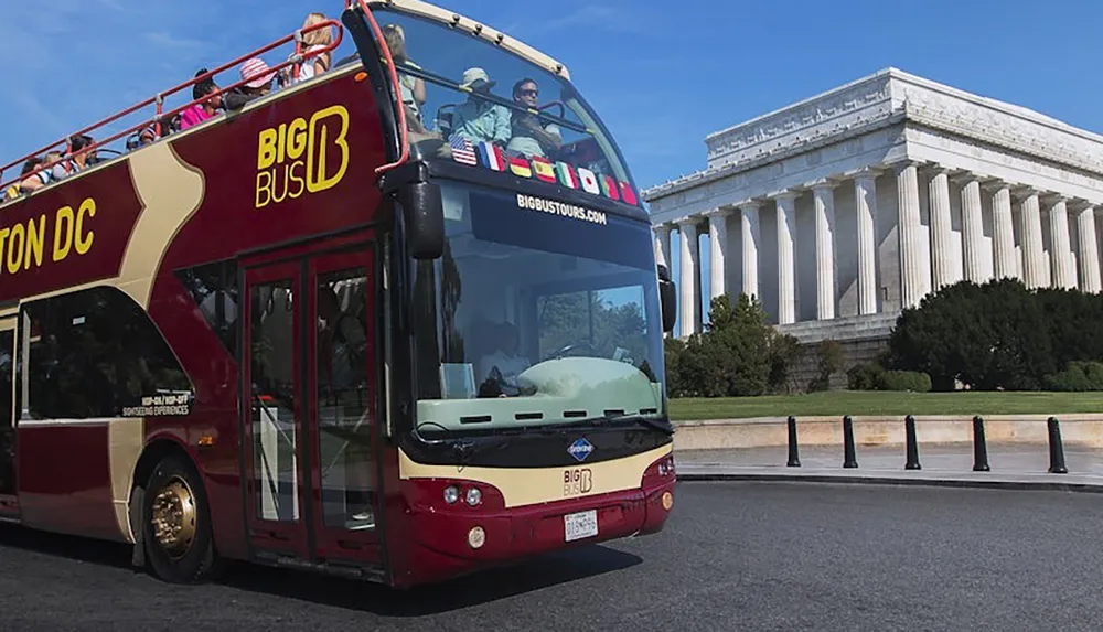 A double-decker sightseeing bus with tourists is passing by the Lincoln Memorial in Washington DC