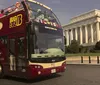 A sightseeing double-decker bus labeled Big Bus Washington DC passes by the Lincoln Memorial on a sunny day