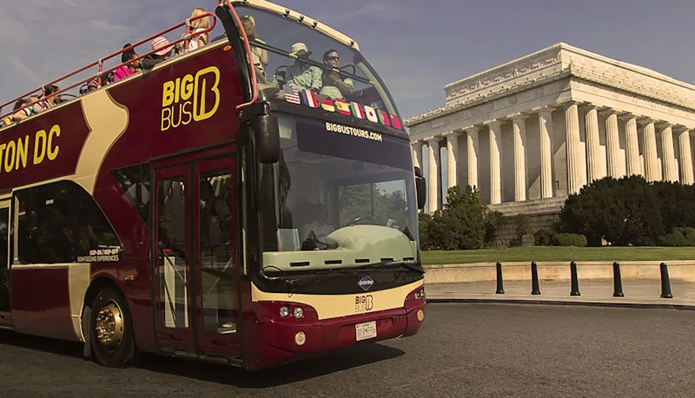 A sightseeing double-decker bus labeled Big Bus Washington DC passes by the Lincoln Memorial on a sunny day